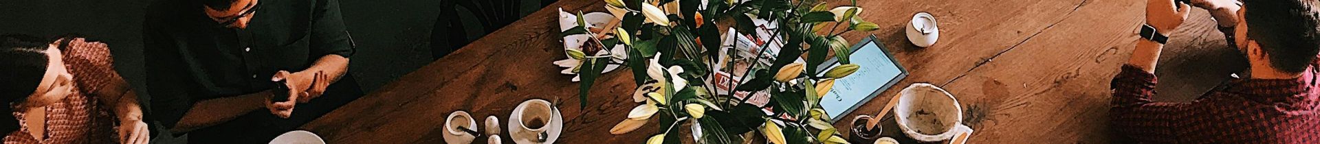 A vibrant aerial view of a busy cafe in Kraków, showcasing patrons enjoying baked goods and coffee.