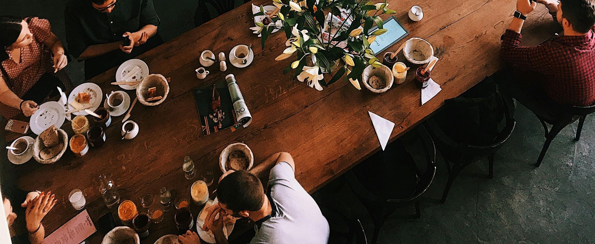 A vibrant aerial view of a busy cafe in Kraków, showcasing patrons enjoying baked goods and coffee.